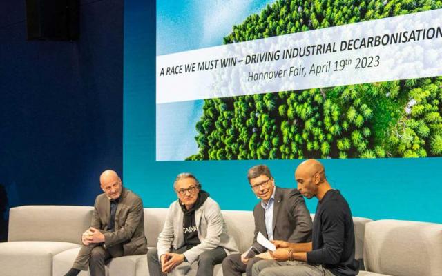 Four men sit together for a discussion at Hannover Messe 2023