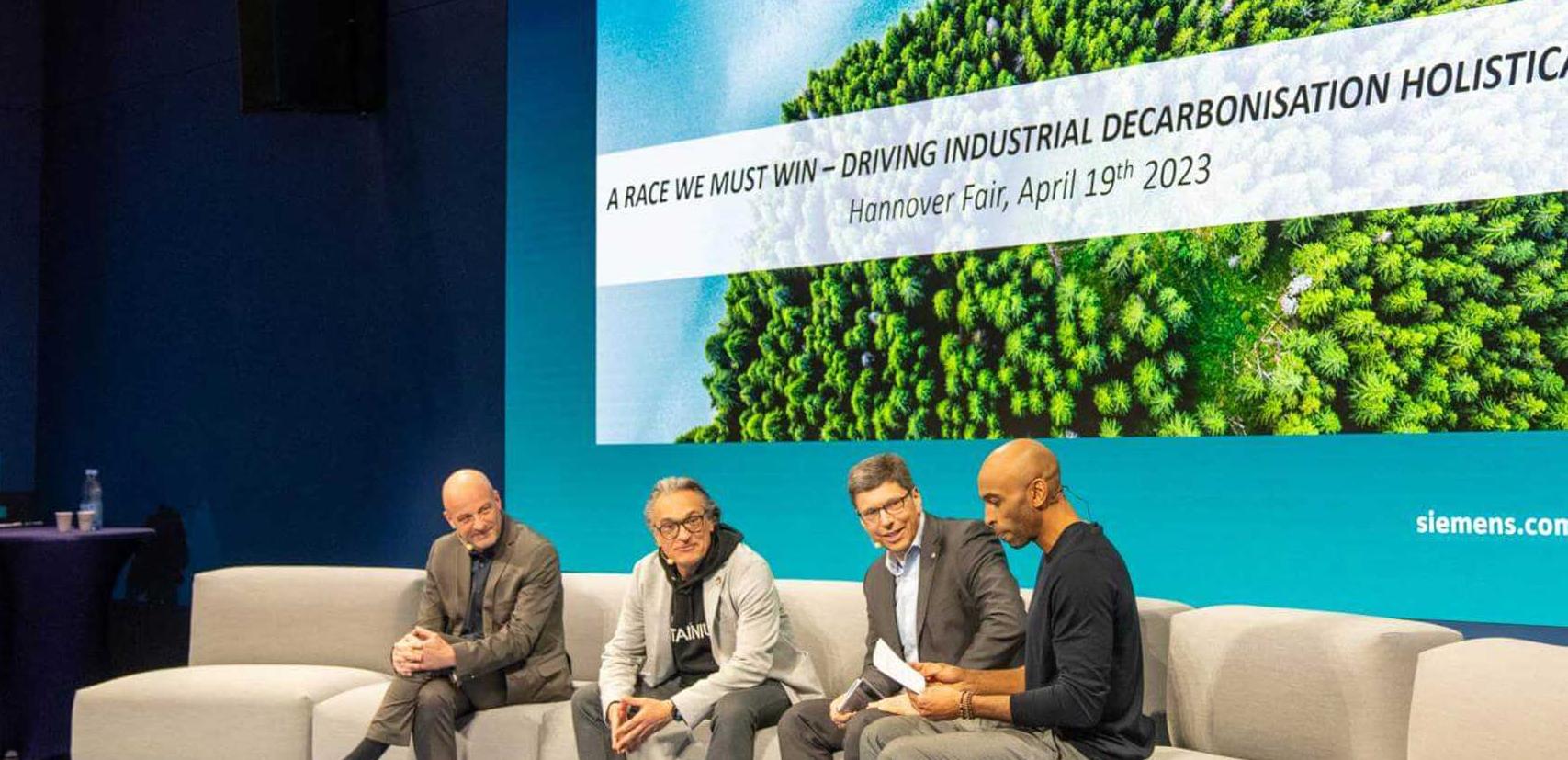 Four men sit together for a discussion at Hannover Messe 2023