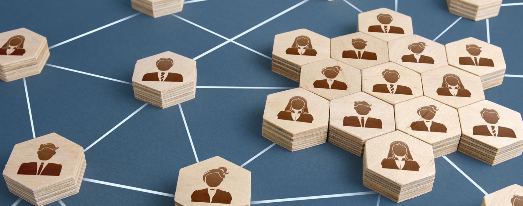 Grid made of wooden blocks with people on it